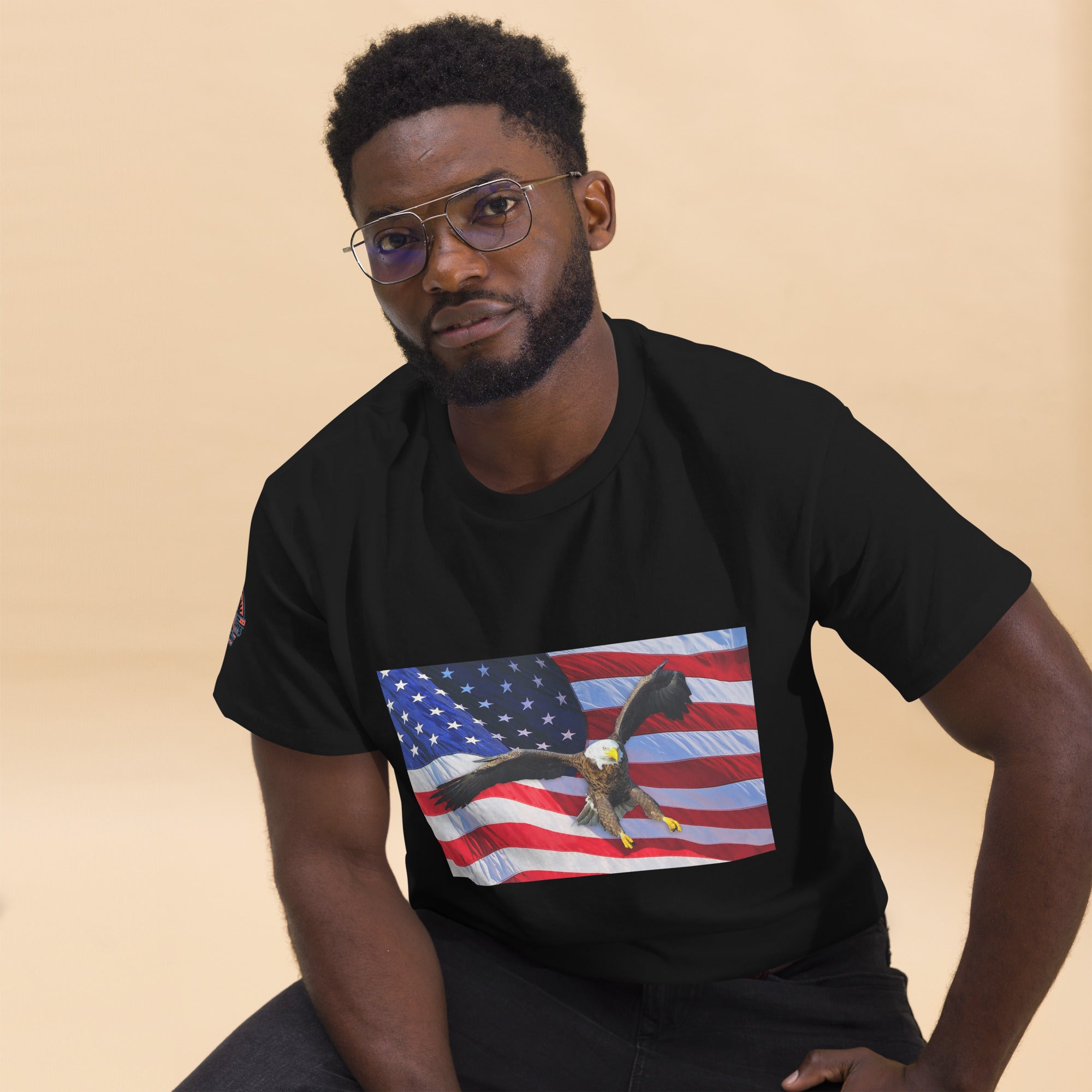 Man wearing a black t-shirt with an American flag and bald eagle design.