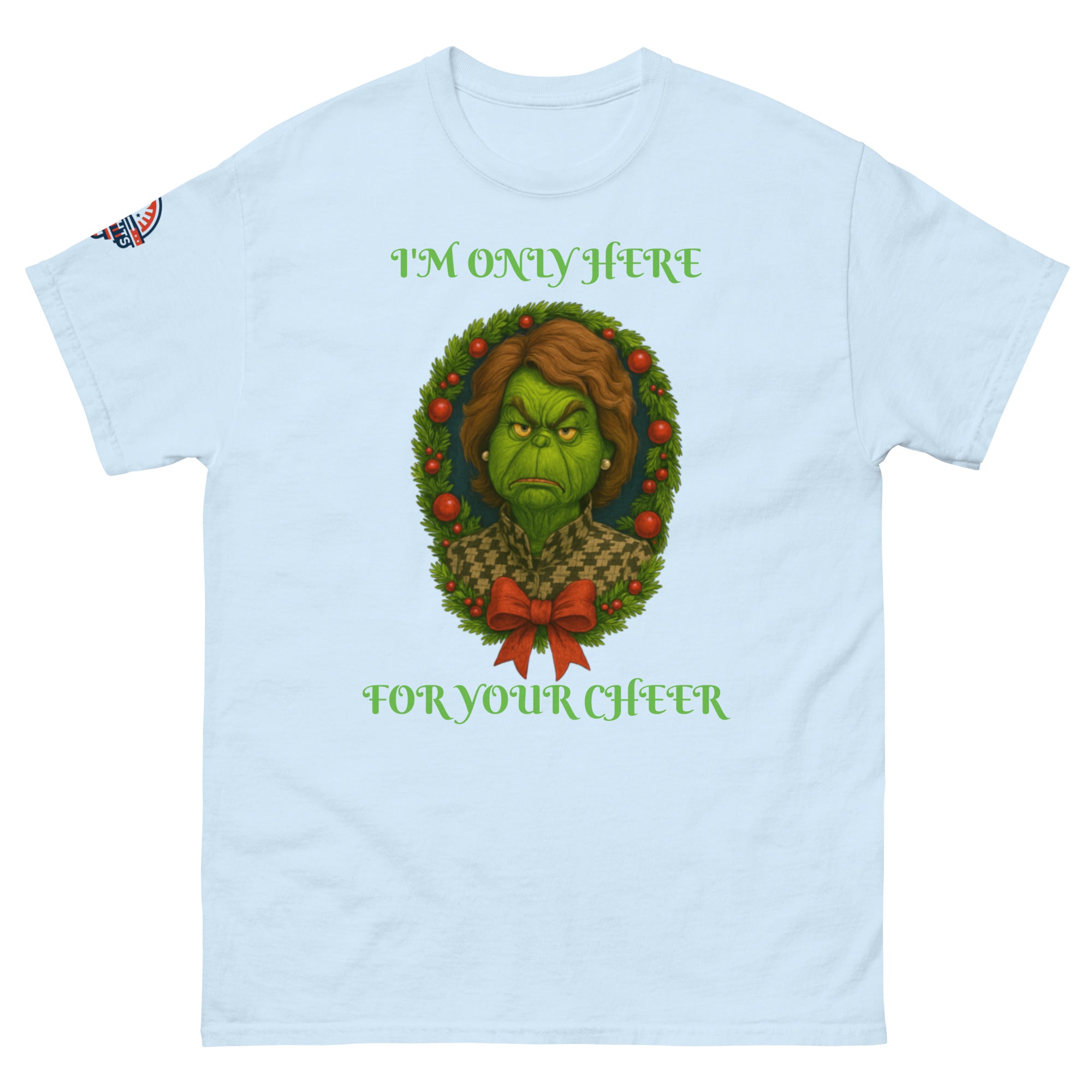 Flat lay light blue unisex Christmas T-shirt with "I'm Only Here For Your Cheer" political holiday wreath design.