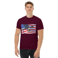 Man wearing a maroon t-shirt with an American flag and bald eagle design 