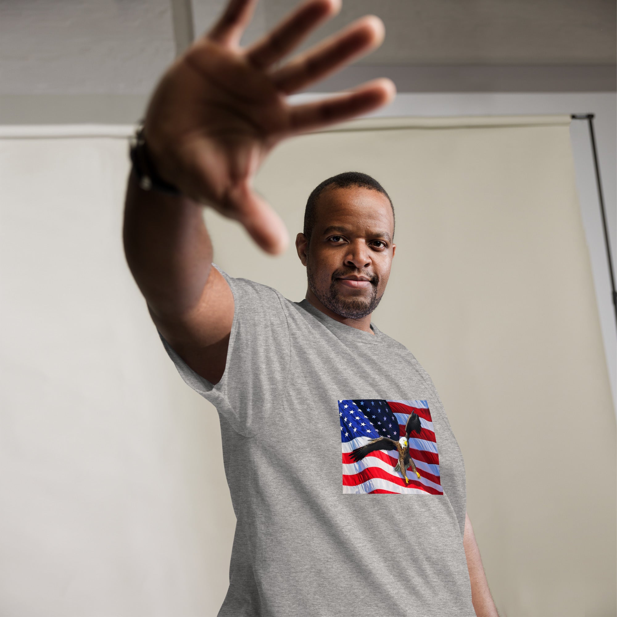 Man wearing a gray big and tall t-shirt with an American flag bald eagle design.