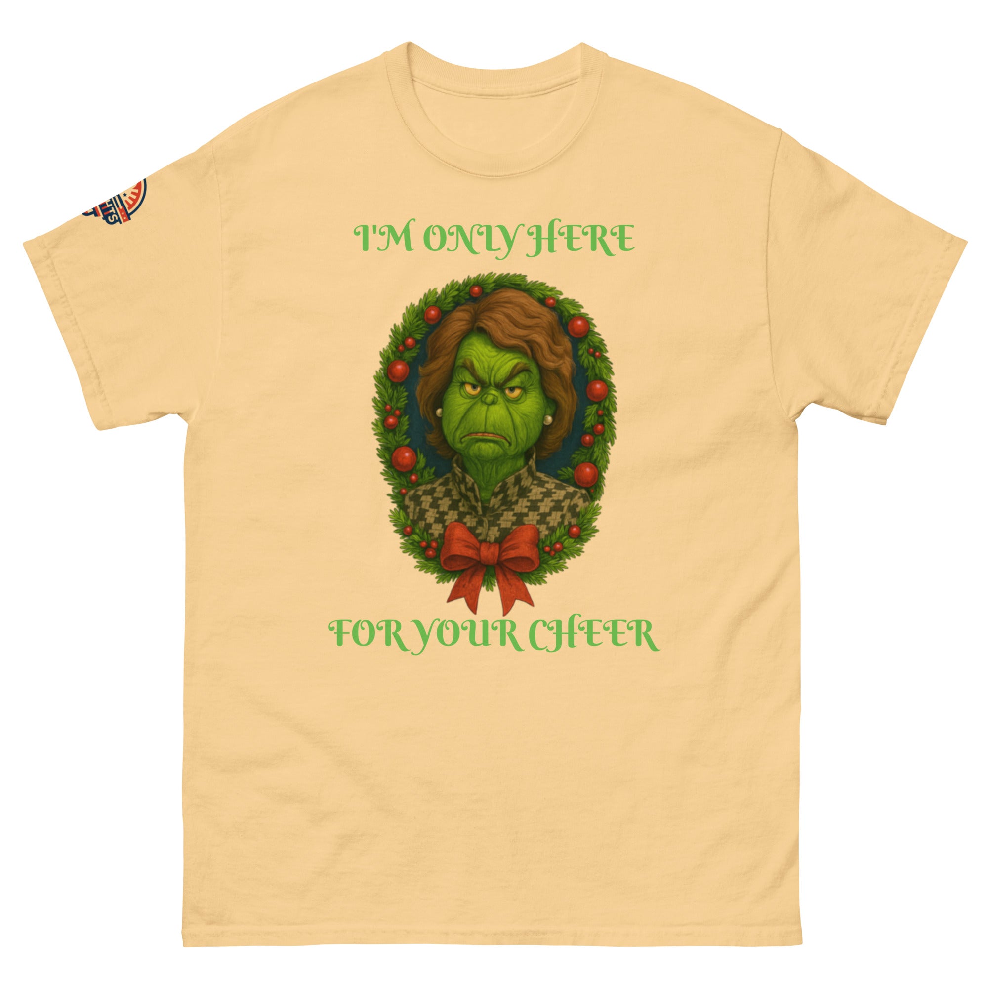Flat lay yellow unisex Christmas T-shirt with "I'm Only Here For Your Cheer" political holiday wreath design.